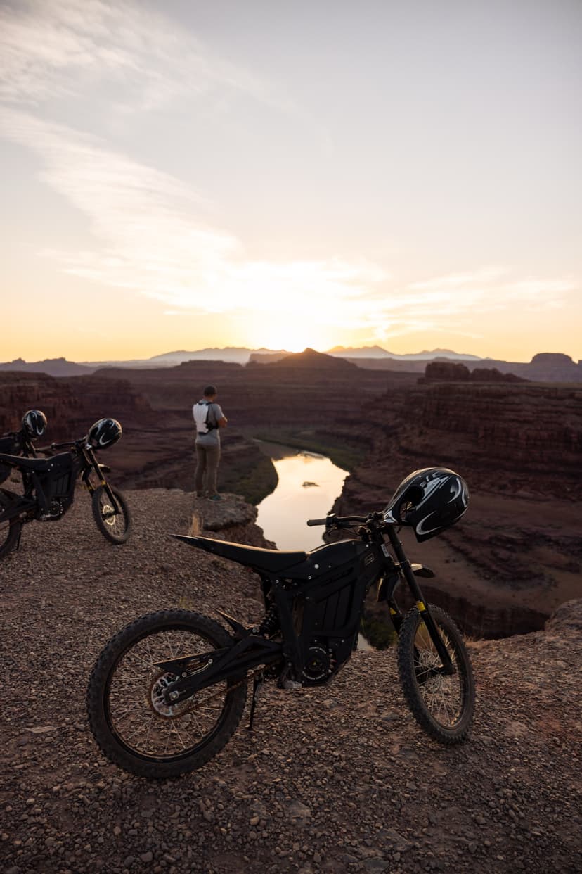 Rider at sunset overlook above the Colorado River canyon